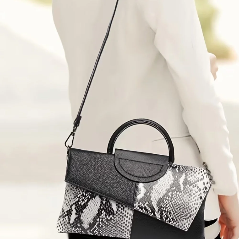 Luce black and white snakeskin clutch bag